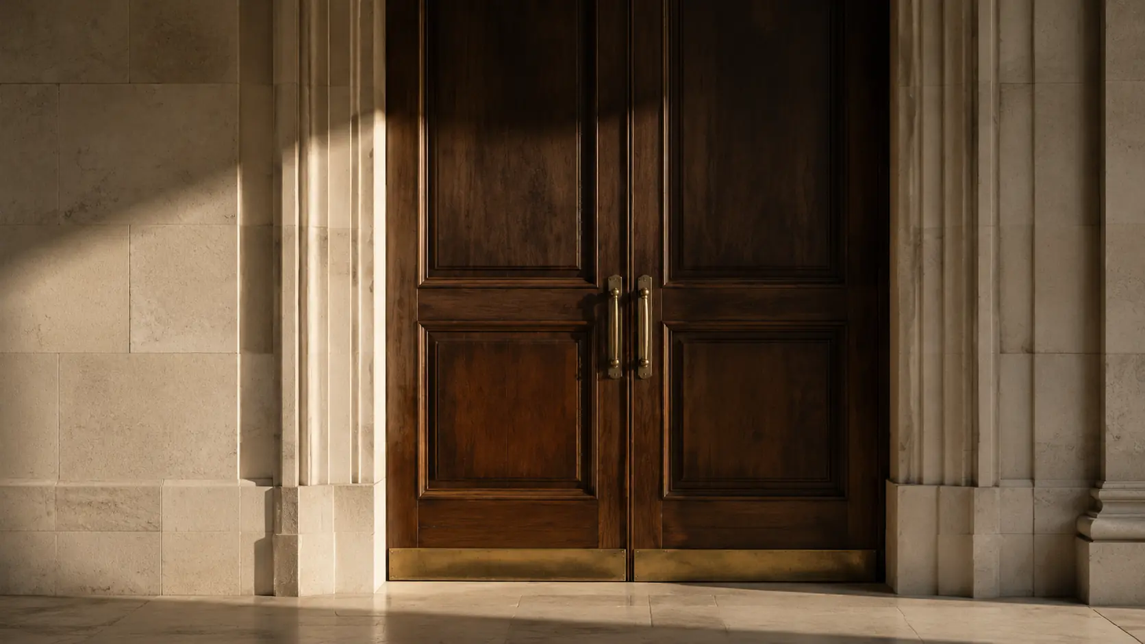 A walnut threshold in limestone, lit by late-afternoon sun