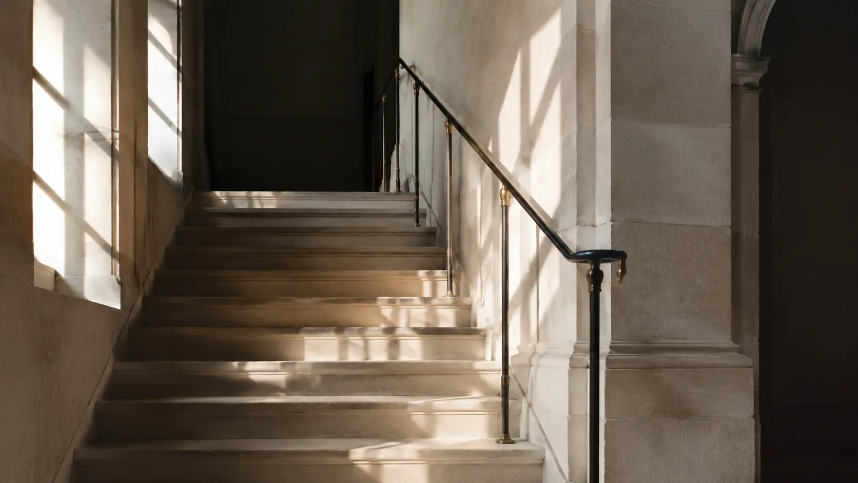 A limestone stair rising toward a private landing